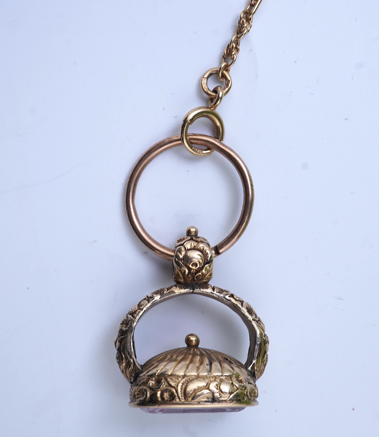 An amethyst fob seal, a gold Albert chain, and a pocket watch